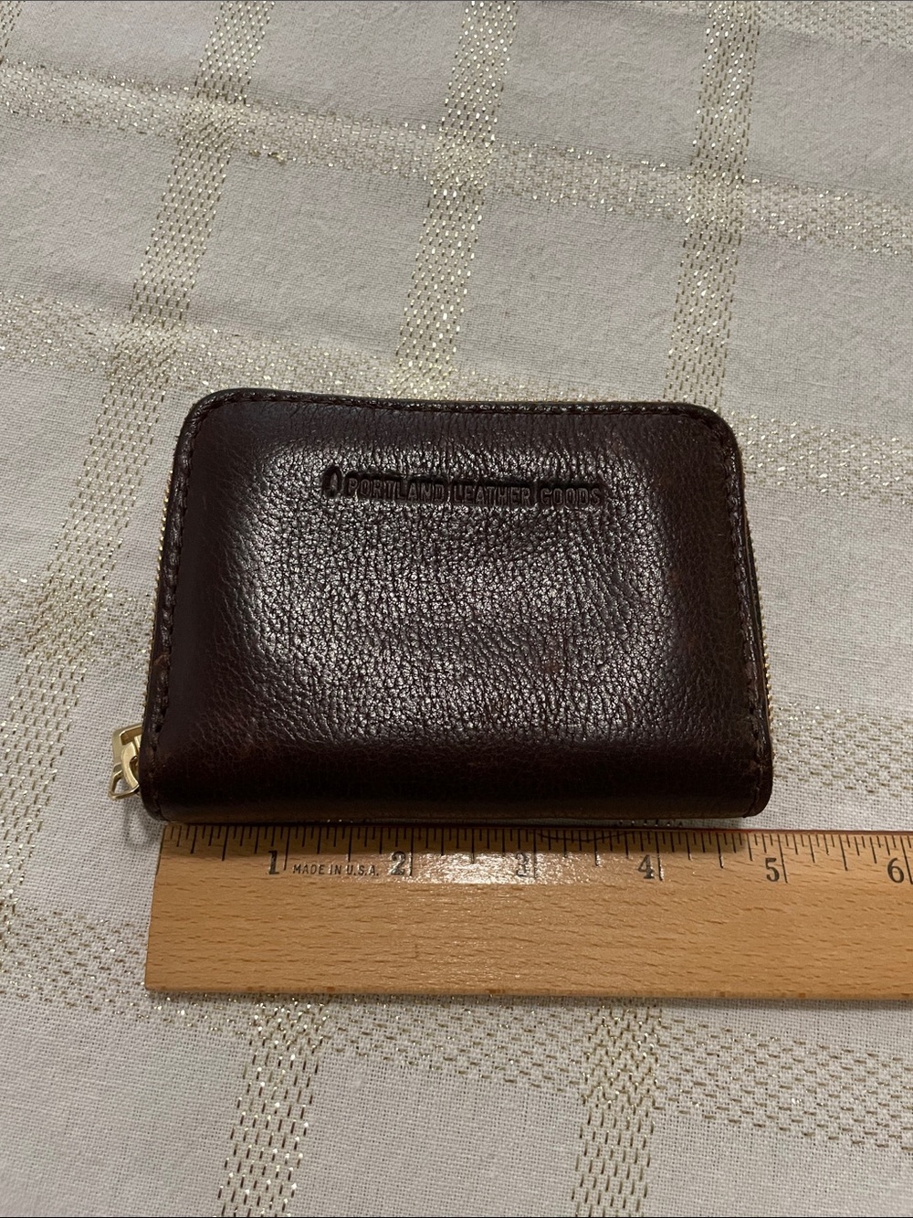 Portland Leather Goods brown wallet, gold tone zipper, inside holds coins/cards